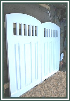 CUSTOM DOUBLE SET OF DOORS ALL REDWOOD BEFORE INSTALLATION ARCH W/WOOD 2X2 INSERT PICTURE WINDOW